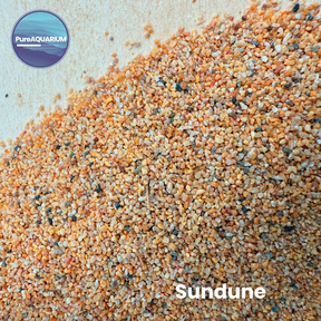 Gravel with a mix of orange, brown, and gray colors on a light background, branded as PureAquarium Sundune gravel.